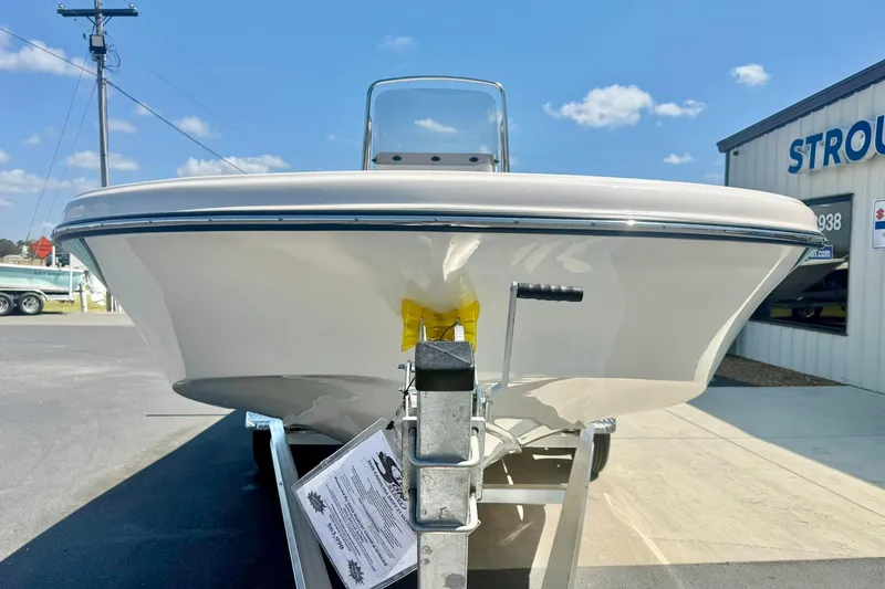 Slide: The Image of 2026 Carolina Skiff 21 Ultra Elite boat on trailer, sunny day, dealership background. - 8