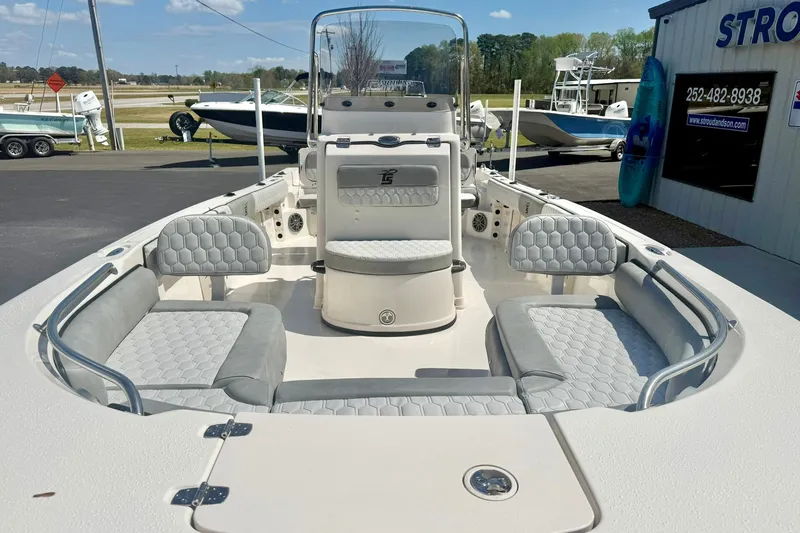 Slide: The Image of 2026 Carolina Skiff 21 Ultra Elite boat interior with gray seating and open deck. - 9