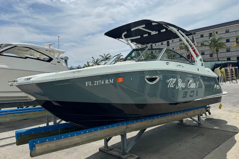 The Image of 2018 Cobalt 23SC boat on a dock, featuring sleek design and modern amenities. - 1
