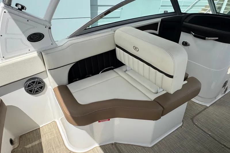 Slide: The Image of 2018 Cobalt 23SC boat interior with white and brown seating. - 11