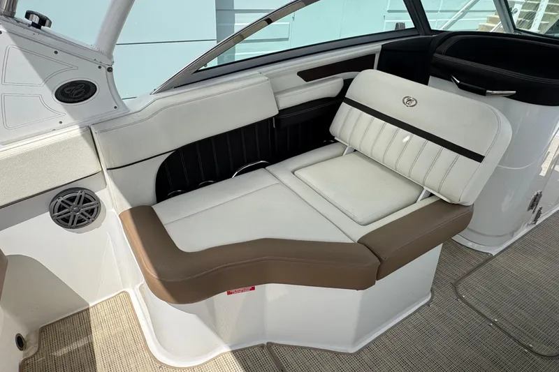 Slide: The Image of 2018 Cobalt 23SC boat interior with white and brown seating, featuring a stylish design. - 12