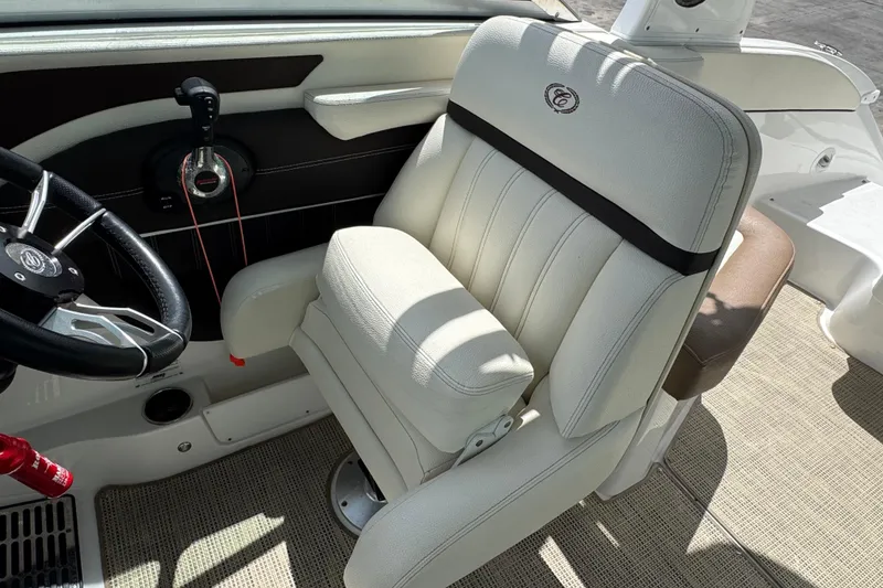 Slide: The Image of Captain's seat and steering wheel of a 2018 Cobalt 23SC boat interior. - 13