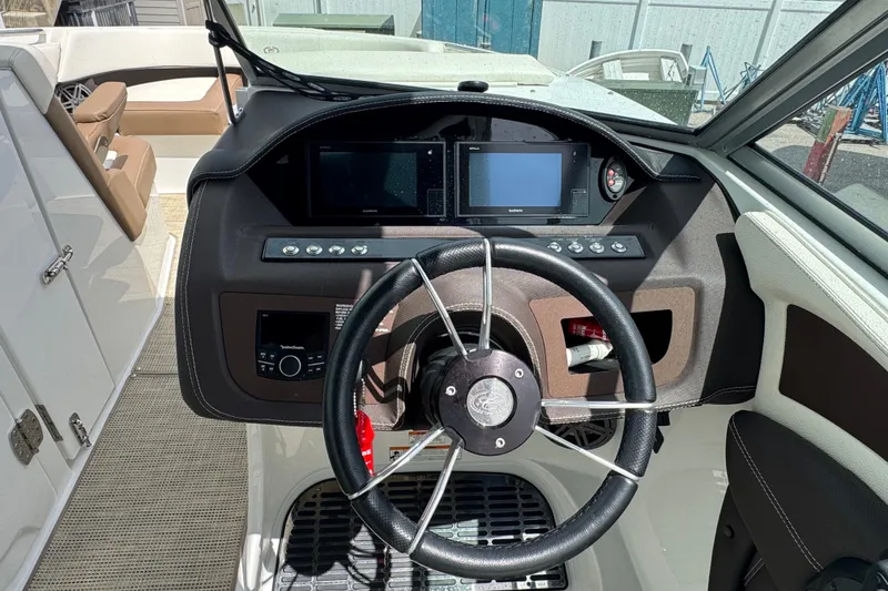 Slide: The Image of 2018 Cobalt 23SC boat dashboard with steering wheel and navigation controls. - 14
