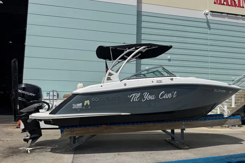 Slide: The Image of 2018 Cobalt 23SC boat with "Til You Can't" text, docked outside a marina. - 5
