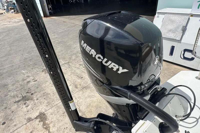 Slide: The Image of Mercury outboard motor on 2018 Cobalt 23SC boat, docked on concrete surface. - 6