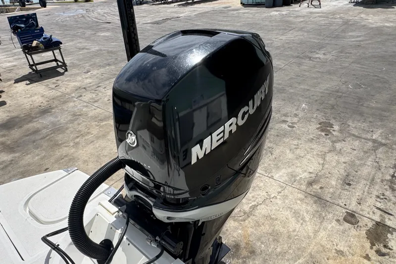 Slide: The Image of Mercury outboard motor on a 2018 Cobalt 23SC boat, parked on concrete. - 7