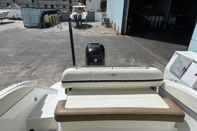 Slide: The Image of 2018 Cobalt 23SC boat with outboard motor in a marina setting. - 8