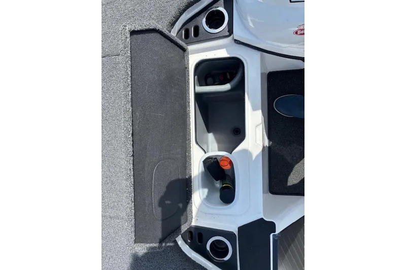 Slide: The Image of 2019 Nitro Z19 boat storage compartments with cup holders and carpeted flooring. - 10