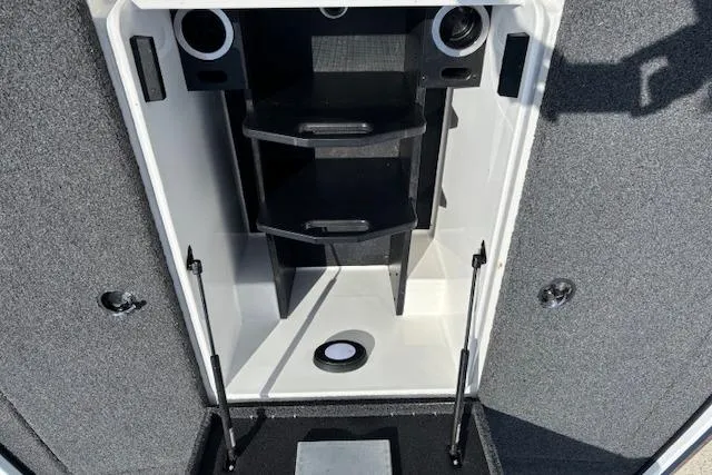 Slide: The Image of 2019 Nitro Z19 boat storage compartment with organized shelving and secure latches. - 13