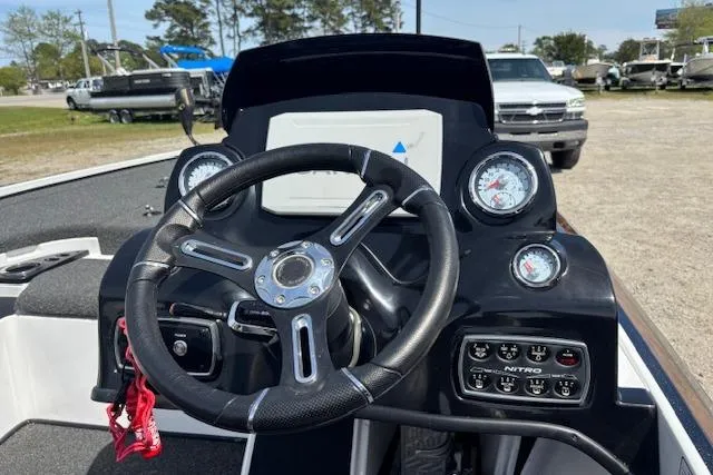 Slide: The Image of 2019 Nitro Z19 boat dashboard with steering wheel and gauges in outdoor setting. - 16