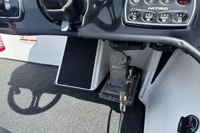 Slide: The Image of Interior view of a 2019 Nitro Z19 boat dashboard with control panel and foot pedal. - 17