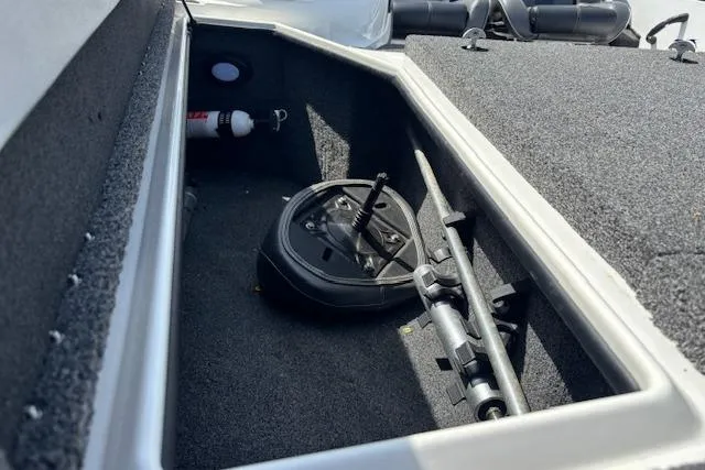Slide: The Image of Storage compartment in a 2019 Nitro Z19 boat, featuring equipment and fire extinguisher. - 20