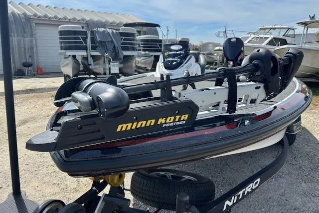 Slide: The Image of 2019 Nitro Z19 boat with Minn Kota trolling motor in a marina setting. - 23
