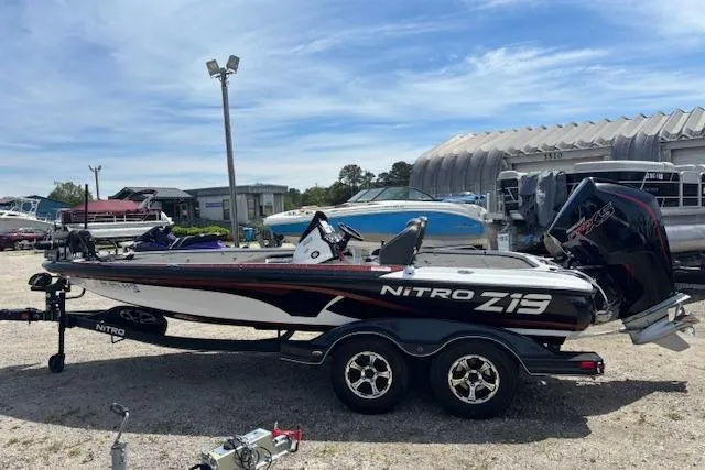 Slide: The Image of 2019 Nitro Z19 boat on trailer, parked outdoors under a clear sky. - 4