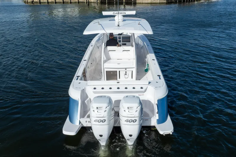 Slide: The Image of 2022 Intrepid 345 Nomad SE boat with twin 400 engines on water. - 10