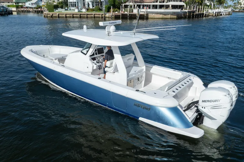 Slide: The Image of 2022 Intrepid 345 Nomad SE boat cruising on calm waters. - 11