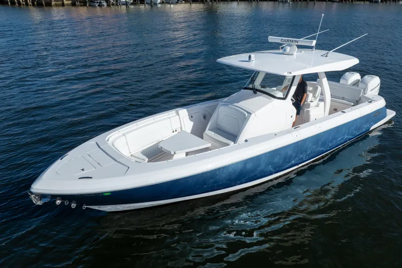 Slide: The Image of 2022 Intrepid 345 Nomad SE boat on water, featuring sleek design and modern amenities. - 14