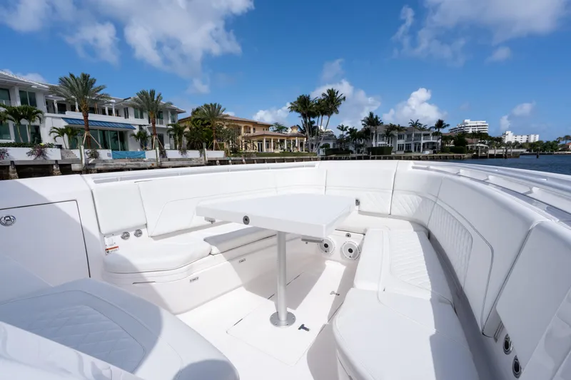 Slide: The Image of Luxurious seating area on 2022 Intrepid 345 Nomad SE boat, with waterfront view. - 19