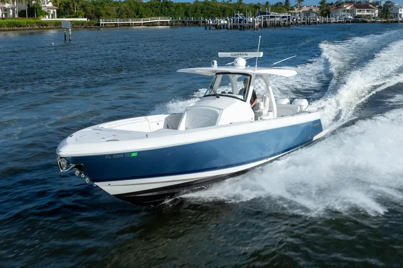 Slide: The Image of 2022 Intrepid 345 Nomad SE boat cruising on a sunny day. - 2