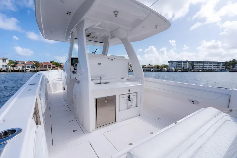 Slide: The Image of 2022 Intrepid 345 Nomad SE boat interior with sleek design and waterfront view. - 31