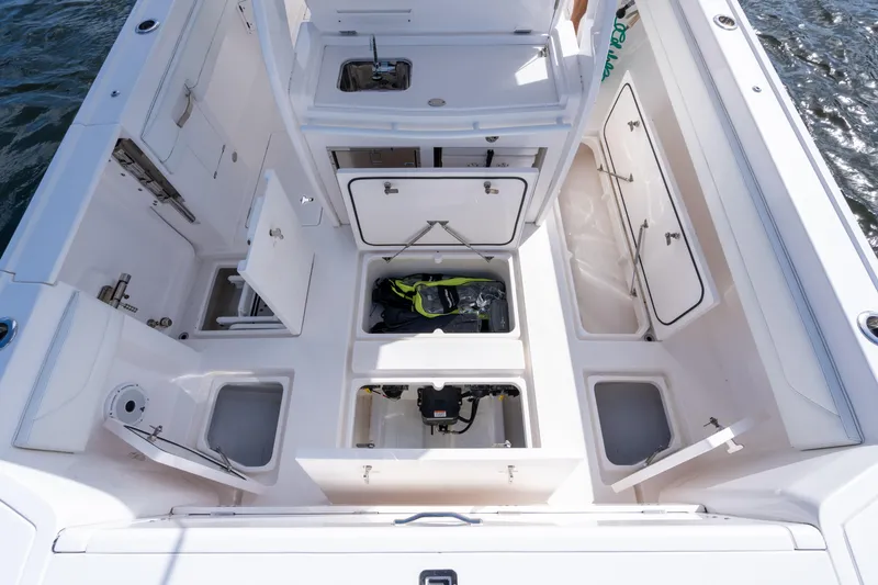 Slide: The Image of 2022 Intrepid 345 Nomad SE boat deck with open storage compartments. - 33