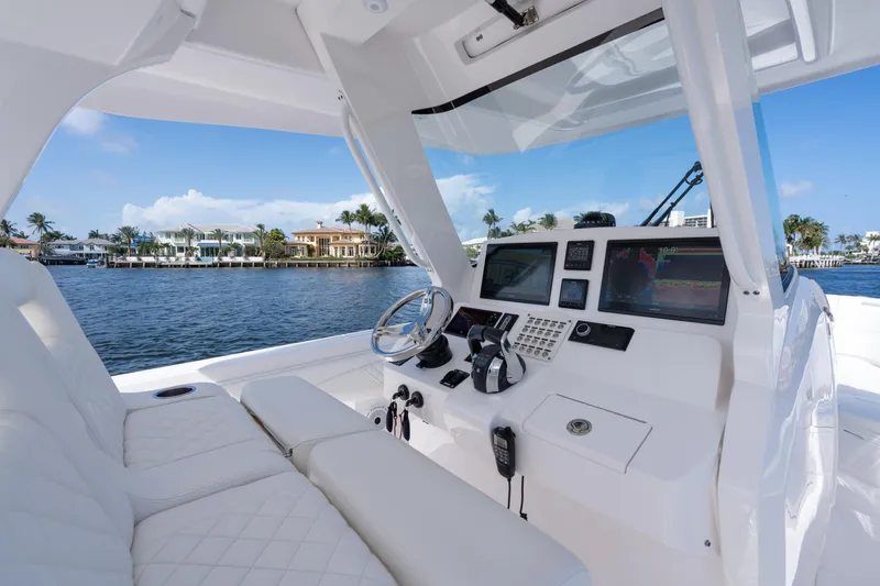 Slide: The Image of 2022 Intrepid 345 Nomad SE boat cockpit with luxurious seating and advanced navigation system. - 35