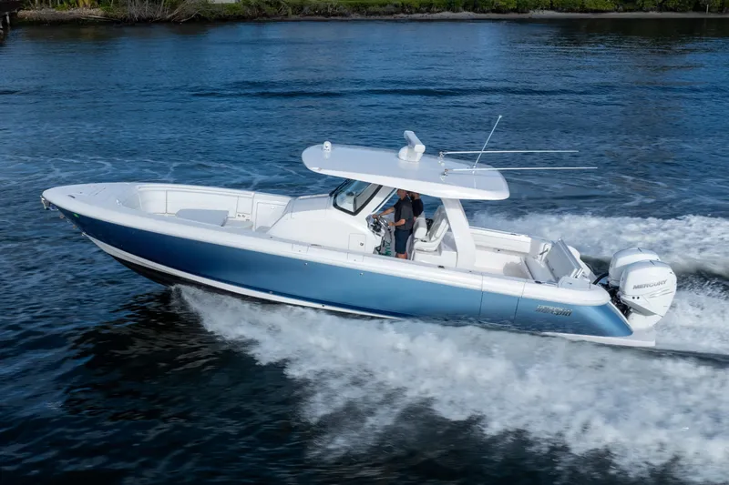 Slide: The Image of 2022 Intrepid 345 Nomad SE cruising on open water, showcasing sleek design and performance. - 4