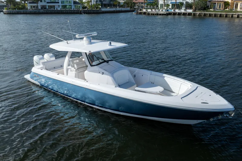 Slide: The Image of 2022 Intrepid 345 Nomad SE boat on calm water, featuring sleek design and modern amenities. - 9