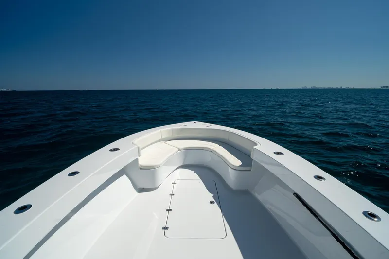 Slide: The Image of Bow view of 2026 Conch 33 boat on open sea under clear blue sky. - 10