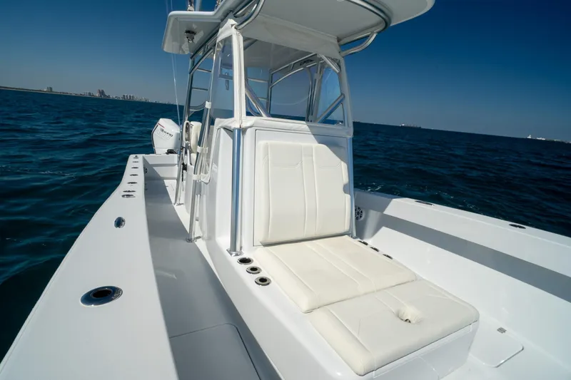 Slide: The Image of 2026 Conch 33 boat with white seating, cruising on open blue water. - 12