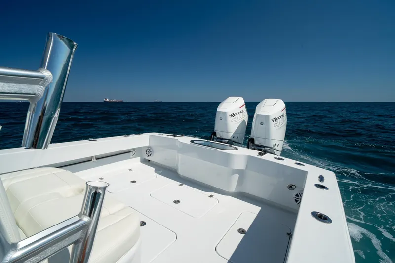 Slide: The Image of 2026 Conch 33 boat with twin outboard engines on open sea. - 14