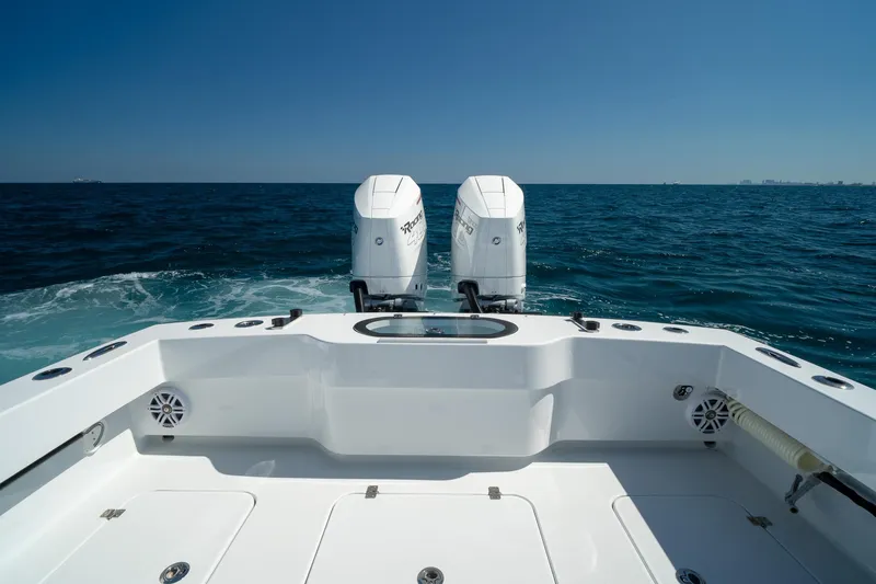 Slide: The Image of Conch 33 boat, 2026 model, with twin engines on open sea under clear blue sky. - 15
