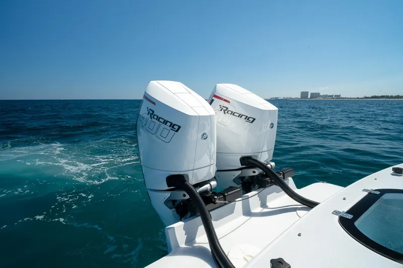 Slide: The Image of Twin outboard motors on a 2026 Conch 33 boat cruising in open ocean waters. - 17
