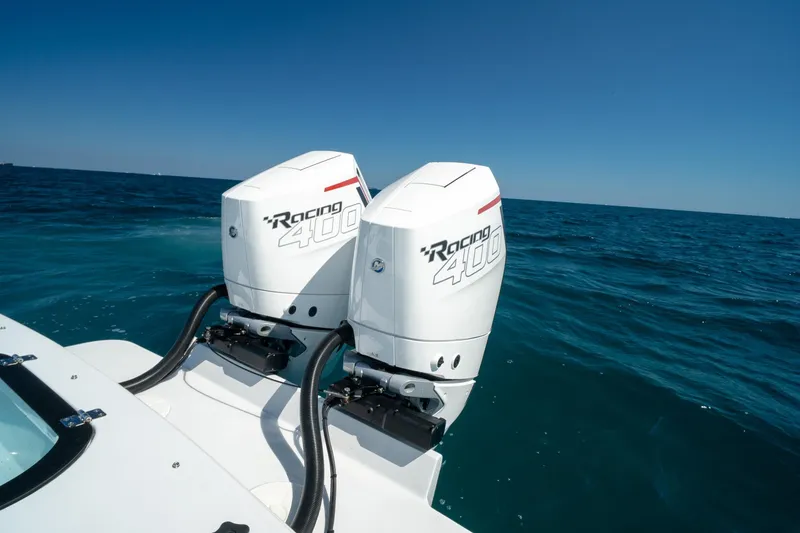 Slide: The Image of Twin Racing 400 outboard engines on a 2026 Conch 33 boat in open sea. - 19