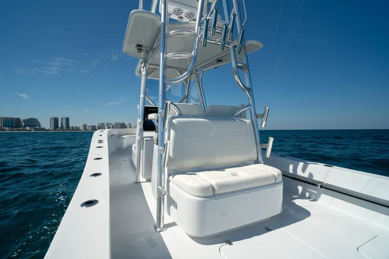 Slide: The Image of 2026 Conch 33 boat on open sea with city skyline in background. - 20