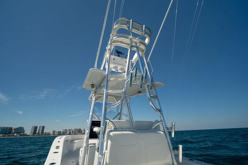 Slide: The Image of 2026 Conch 33 boat with tower against clear blue sky and ocean backdrop. - 21