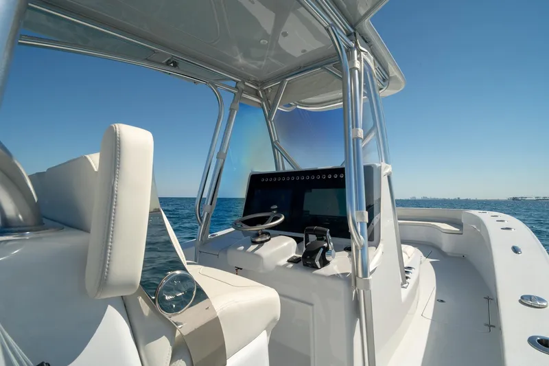 Slide: The Image of 2026 Conch 33 boat interior with steering console on open water. - 27