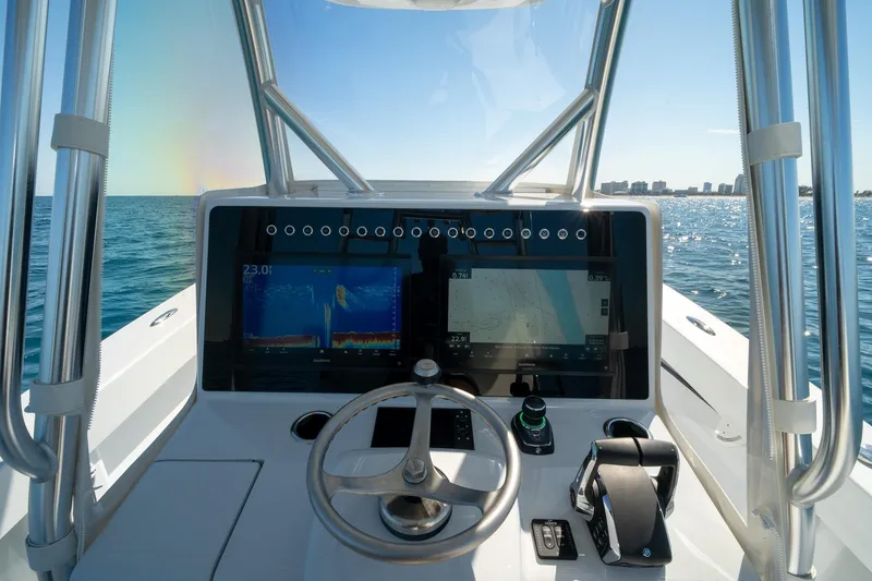 Slide: The Image of Cockpit view of 2026 Conch 33 boat with advanced navigation screens on open water. - 29