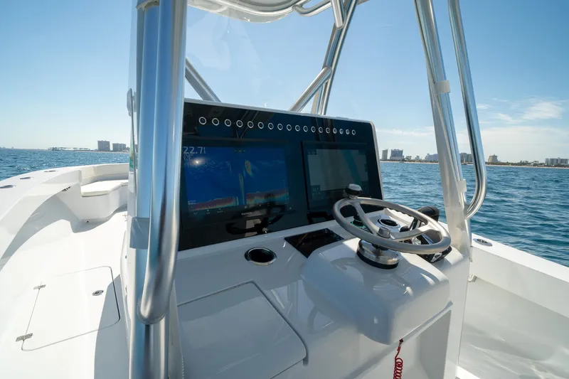 Slide: The Image of Modern Conch 33 boat dashboard with steering wheel and navigation screen, 2026 model. - 30