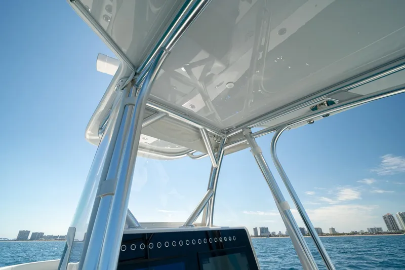 Slide: The Image of 2026 Conch 33 boat with sleek metal framework and ocean backdrop. - 31