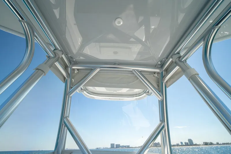 Slide: The Image of View from a 2026 Conch 33 boat, showcasing sleek metal framework against a clear blue sky. - 32