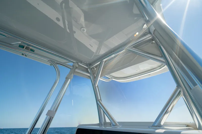 Slide: The Image of View from a 2026 Conch 33 boat, showcasing sleek metal framework and clear blue sky. - 33