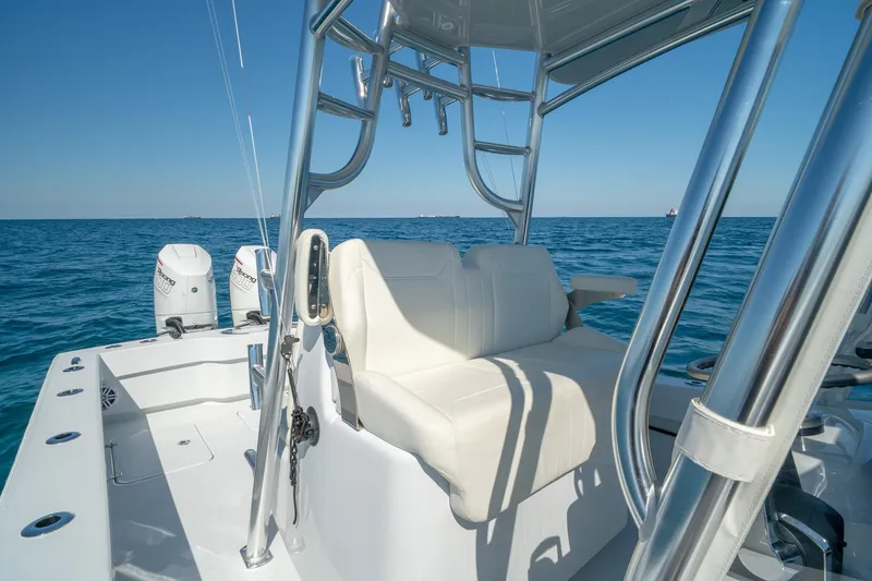 Slide: The Image of 2026 Conch 33 boat with white seating and dual engines on open water. - 34