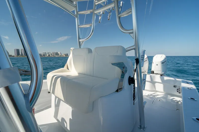 Slide: The Image of 2026 Conch 33 boat interior with white seating, ocean view, and city skyline. - 35