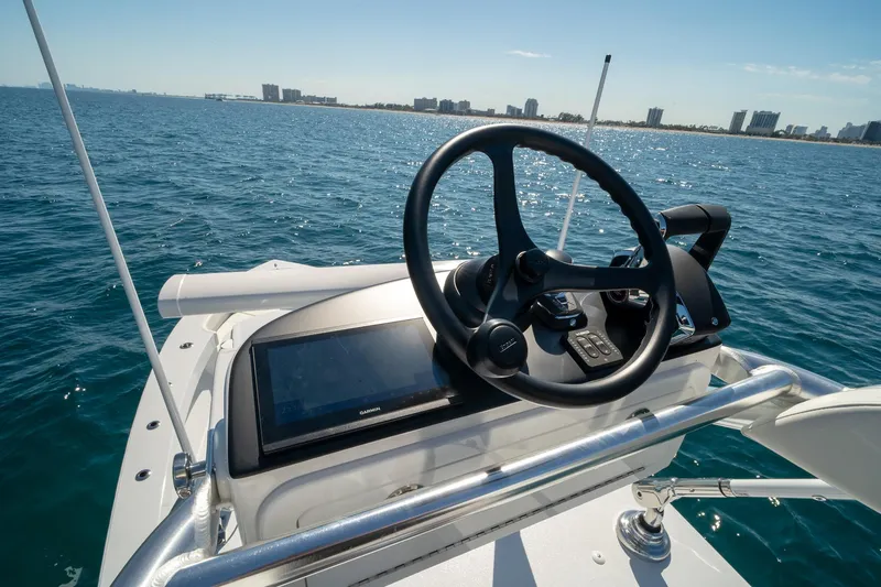 Slide: The Image of Helm of 2026 Conch 33 boat with ocean and city skyline in background. - 37
