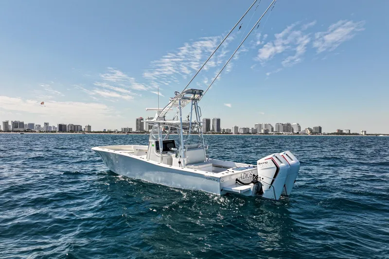 Slide: The Image of 2026 Conch 33 boat on ocean with city skyline in background. - 4