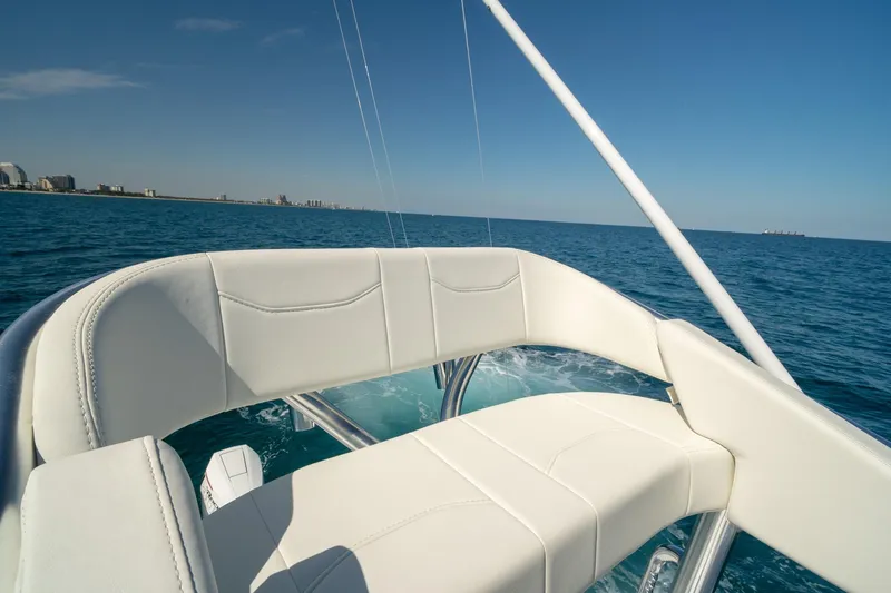 Slide: The Image of 2026 Conch 33 boat with white seating, cruising on open ocean. - 41