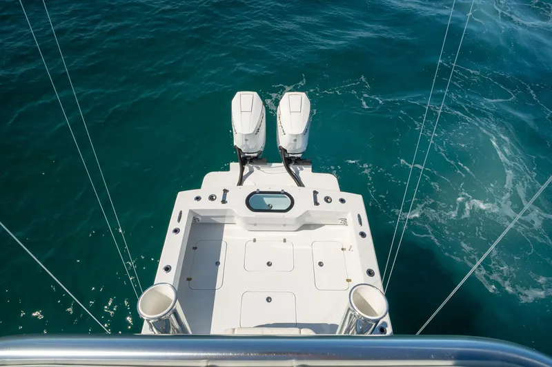 Slide: The Image of 2026 Conch 33 boat with dual engines on clear blue water. - 44