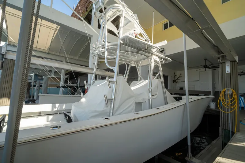 Slide: The Image of 2026 Conch 33 boat docked indoors, showcasing sleek design and modern features. - 46