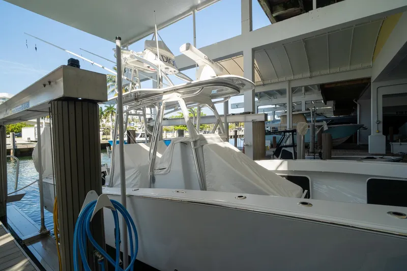 Slide: The Image of 2026 Conch 33 boat docked in a marina under a covered structure. - 47